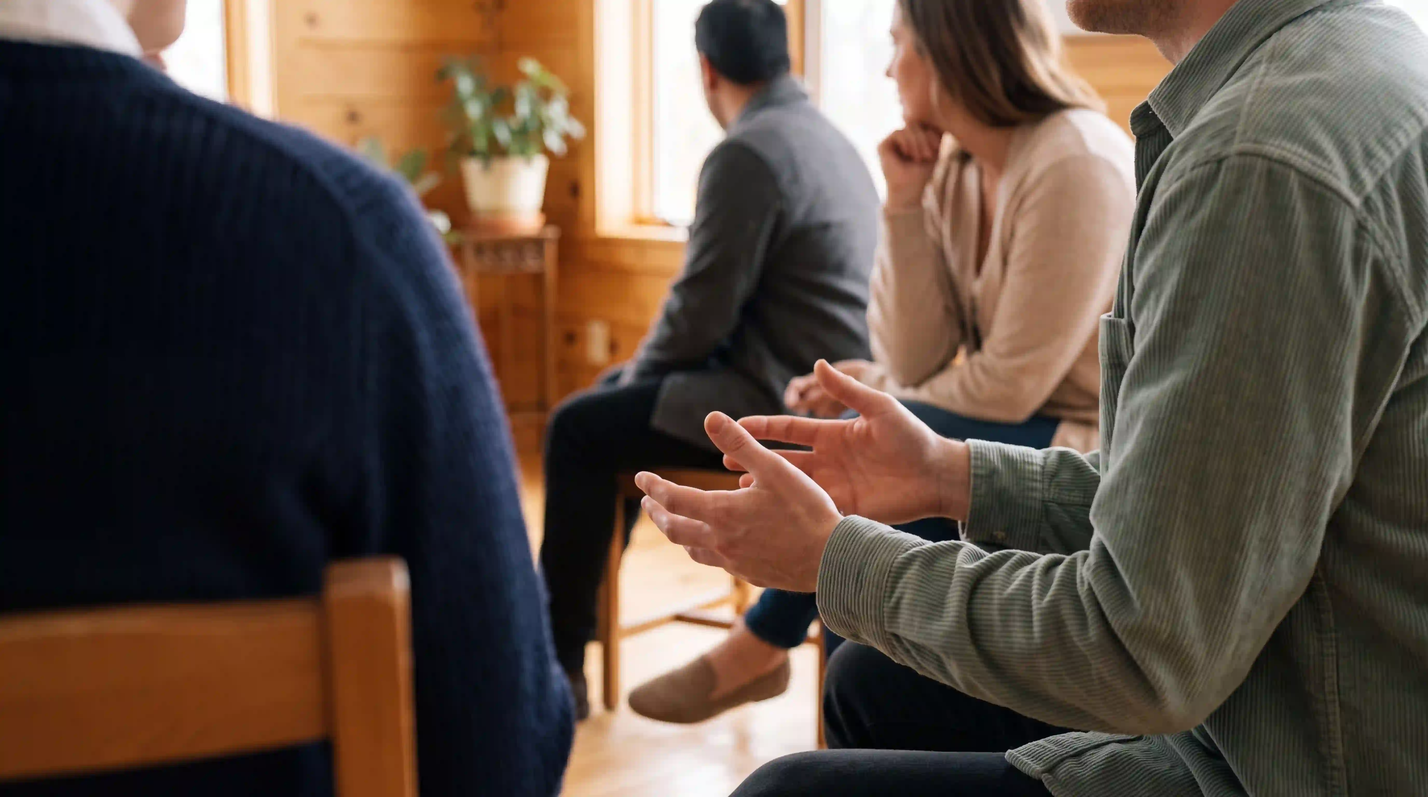 Clients in a group counseling circle at HFGC, engaged in conversation during an Intensive Outpatient Program session